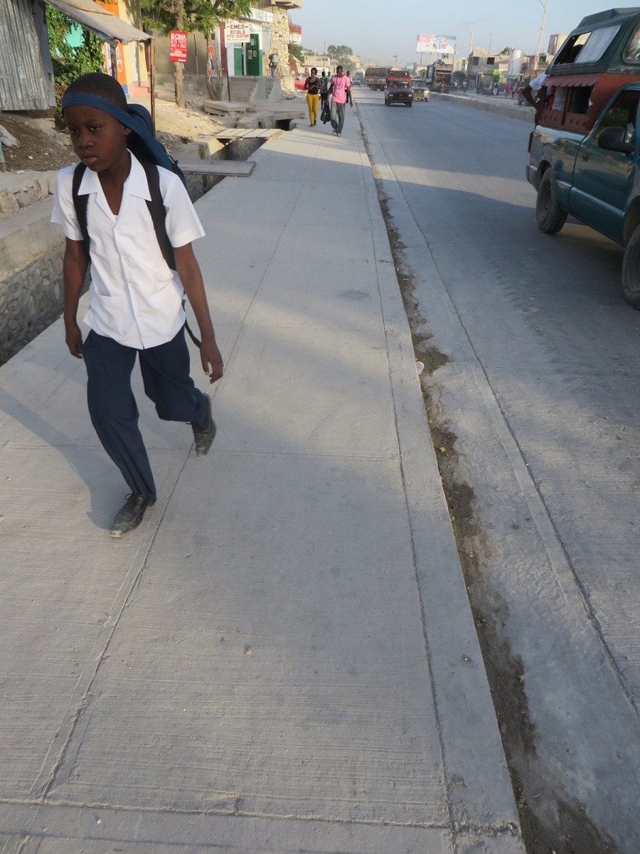 a boy walking in his school uniform
