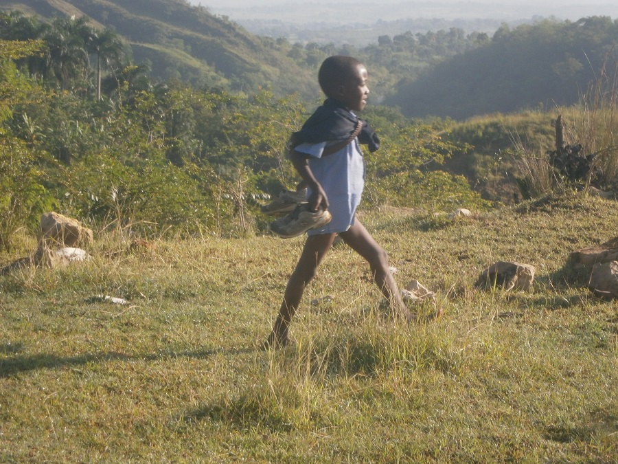 a boy carrying his school uniform pants