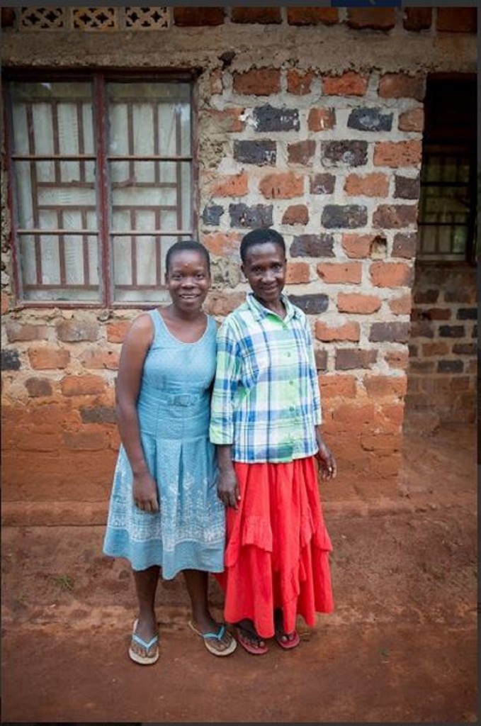 Allen and her grandmother in front of their home 