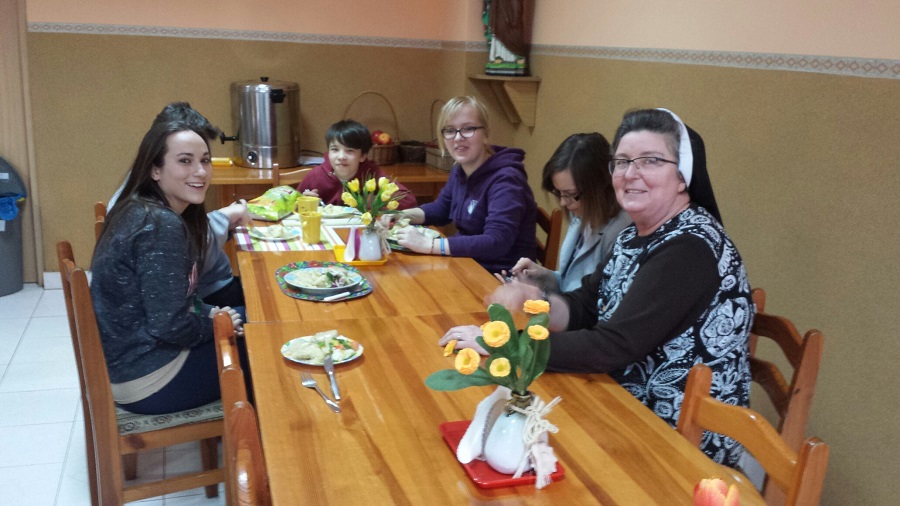 young people with nun sitting at table