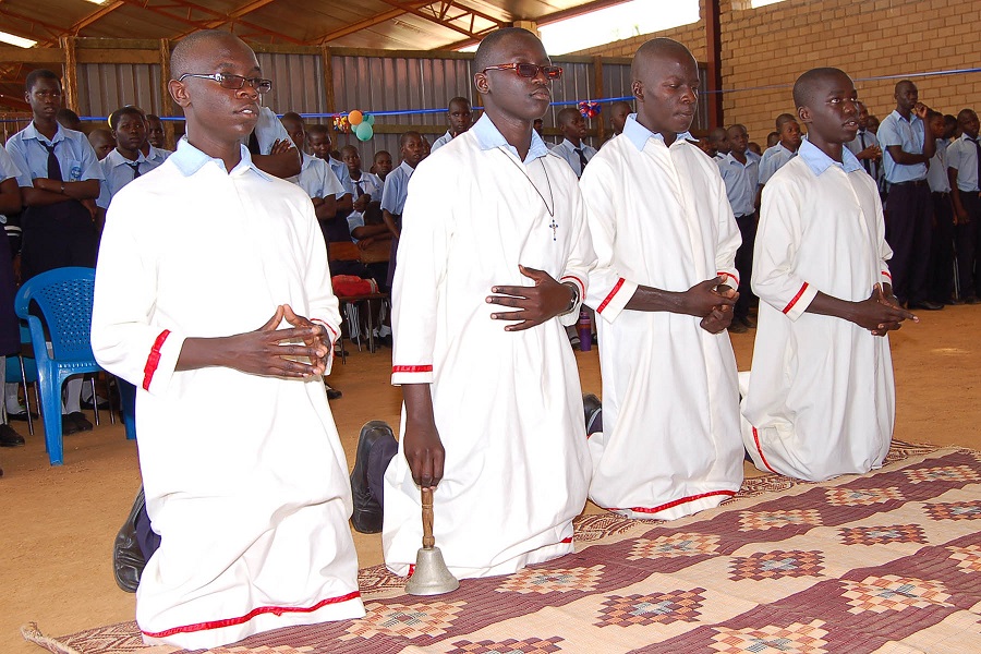 young men kneeling in prayer of thanksgiving