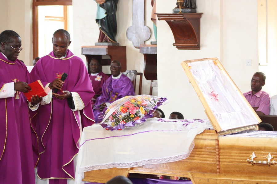 The priests give the final blessing over the late sister