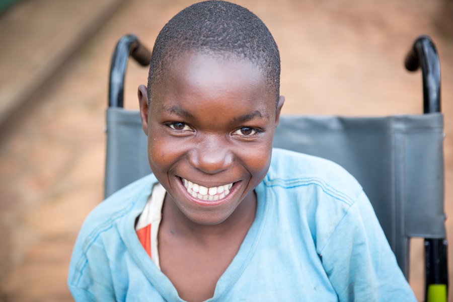 image of smiling girl sitting in wheelchair