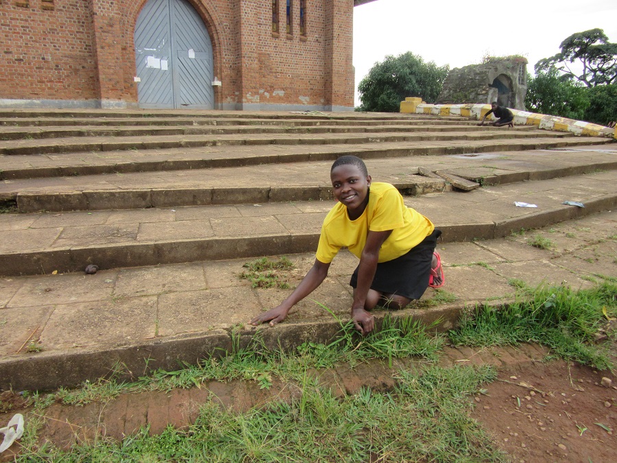 teenage girl kneeling on stone church steps