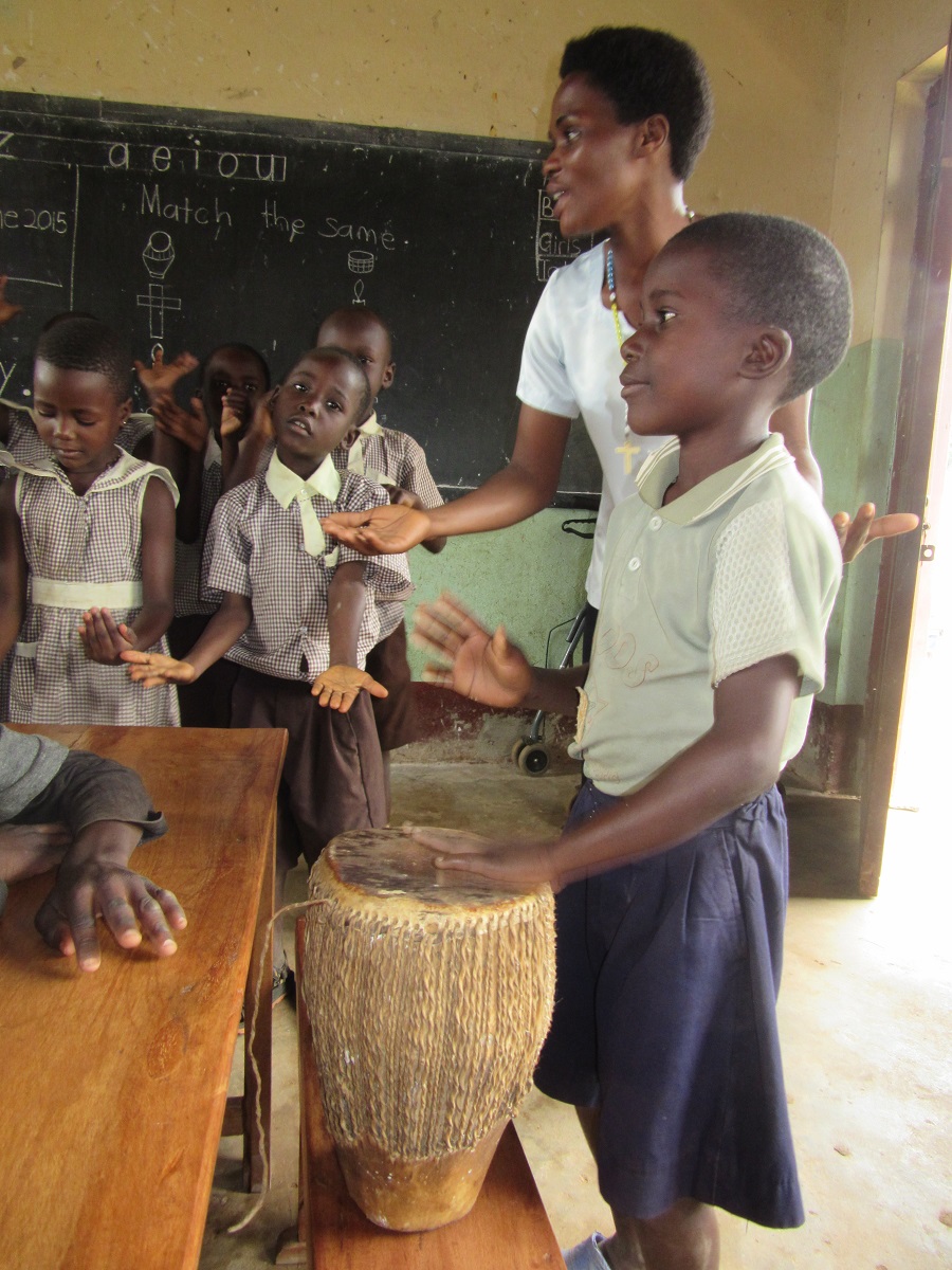 Dan, a student in Top Class at St. Anthony Nursery School,practices playing a drum. St. Anthony is another school in the CARITAS child sponorship programs where one can sponsor a child.
