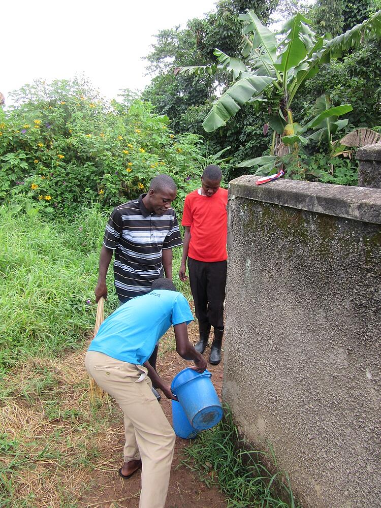 Frank had organized some of the teens in the CARITAS child sponsorship programs to volunteer to clean the Nkokonjeru parish church and grounds recently. Here, Frank enlisted the help of two boys, Laurence, in blue, and Robert, in red, to clean the bathrooms.