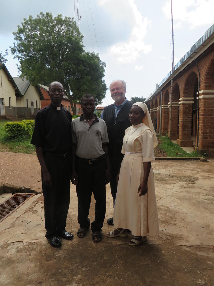 Joseph_center_stands_with_St_Joseph_Minor_Seminary_Nyenga_headteacher_Chris_Sr_Carolyne