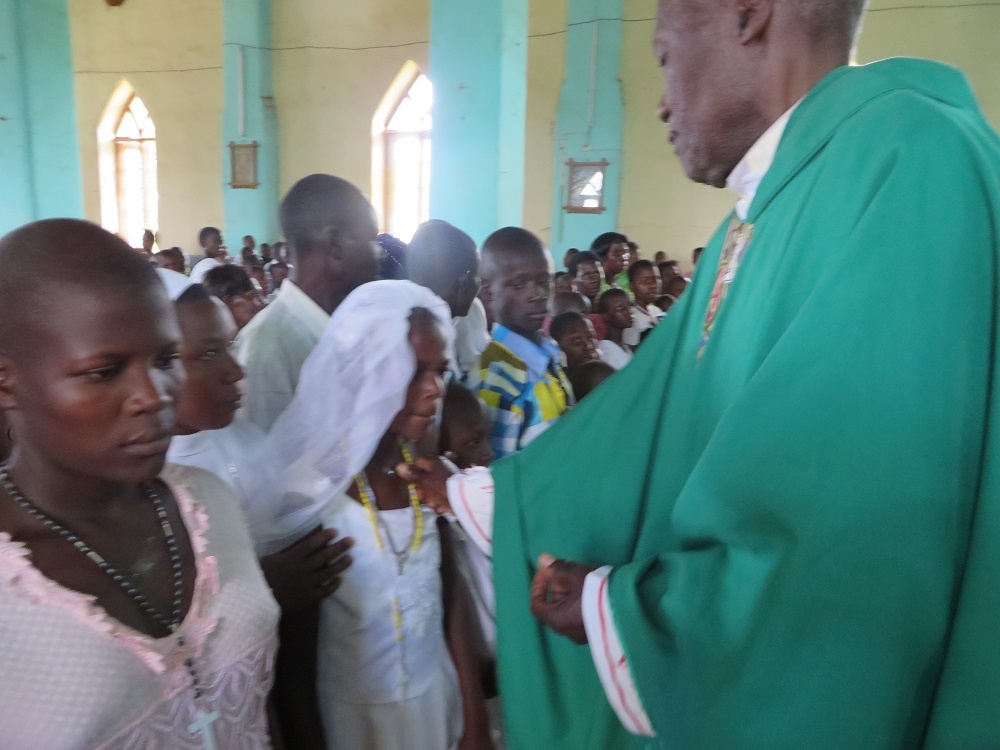 Mary_Lwiza_receiving_the_sacraments_of_Baptism_and_First_Communion
